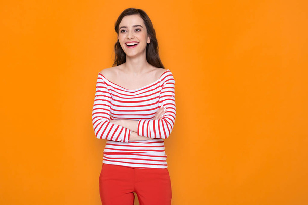 Waist up of happy brunette lady posing for camera in studio - Photo, image