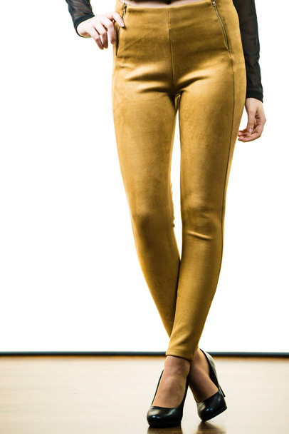 Woman wearing mustard tight pants - Zdjęcie, obraz
