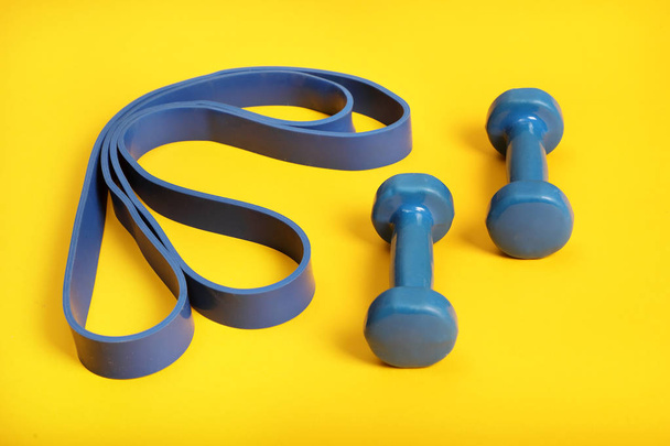 Dumbbells and rubber band for fitness . - Foto, Bild
