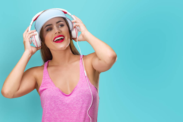 Young woman listening music in headphones - 写真・画像