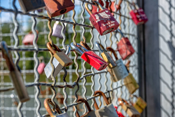 Various locks with names on a metal grid - Photo, Image