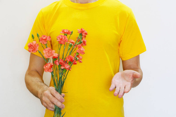 Close-up - a man holds carnation flowers in his hand and stretch - Fotografie, Obrázek