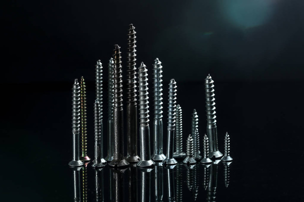 Various screws with reflection, standing like a city  - Фото, изображение