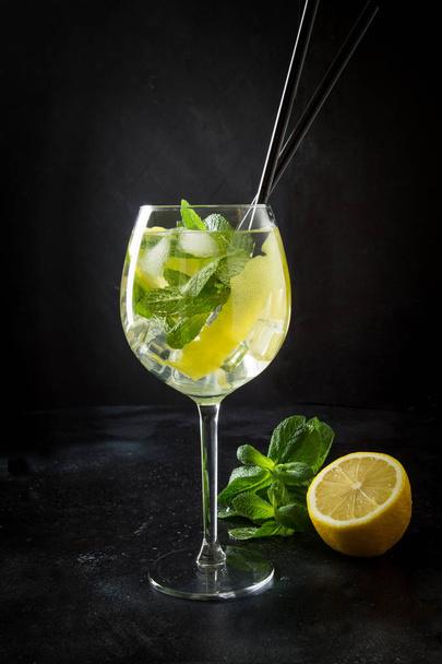 Mojito cocktail or lemonade with mint in glass on black. Close up. Summer drink. - Fotografie, Obrázek