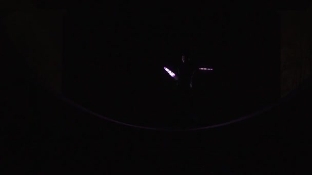 Cirkusový umělec v černém kostýmu dělá triky s LED POI v noci - Záběry, video