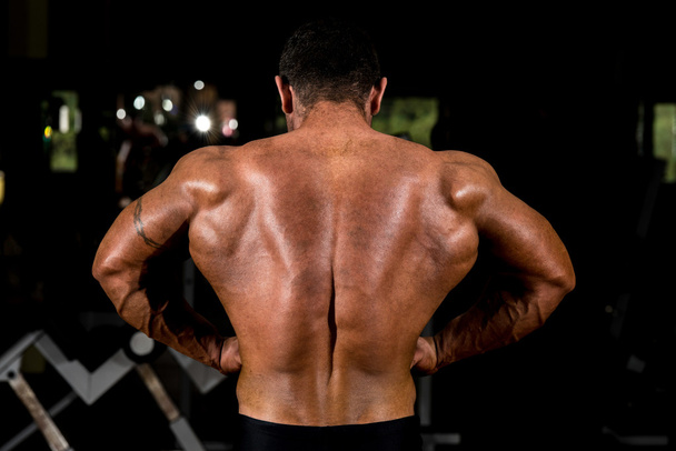 Muscular bodybuilder showing back lat spread - Photo, image