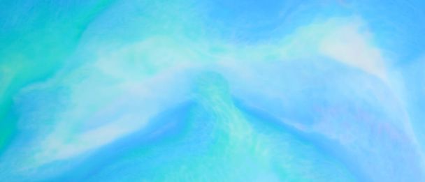 Fluid art. Turquoise abstract background on the liquid. Holographic blue-green background. Multicolored fluid stains. Widescreen - Фото, изображение