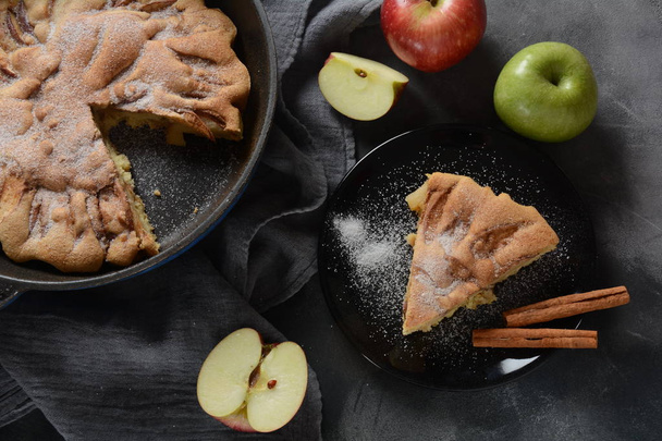 Homemade apple pie with sugar powder and cinnamon. Traditional American or English dessert  - Фото, изображение