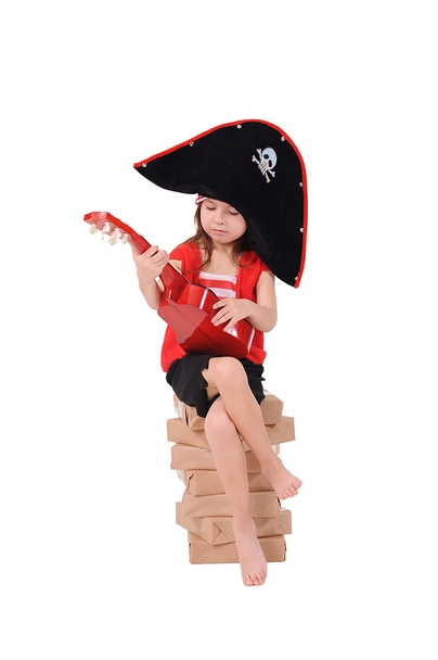 Girl in a costume sits on a stack of paper - Photo, Image