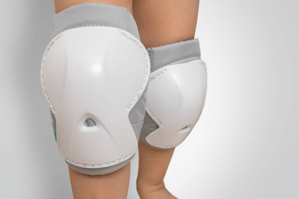 Pair of knee pads wearing on legs of child - Photo, Image