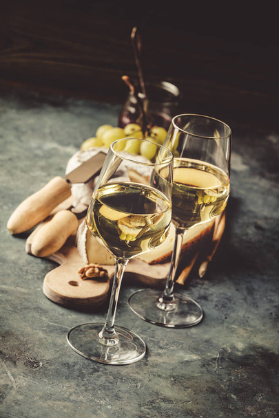 White wine with charcuterie assortment on the stone background - Photo, Image