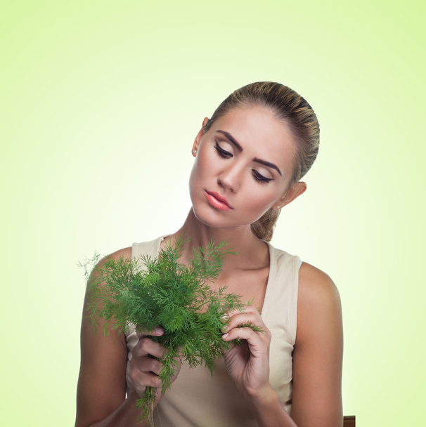 Woman with bundle herbs (salad). Concept vegetarian dieting - Φωτογραφία, εικόνα
