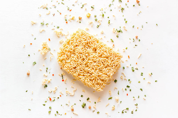 dry instant noodles with seasonings on a white background - Фото, зображення