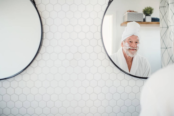 A senior man doing morning routine in bathroom indoors at home. Copy space. - Fotó, kép