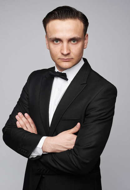 Handsome man in black suit and bow tie isolated - Zdjęcie, obraz