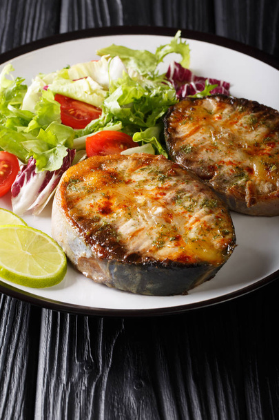 Delicious grilled sturgeon steaks with fresh vegetable salad clo - Photo, Image
