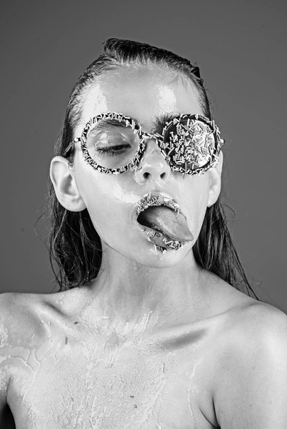 Beauty and fashion model of glamour girl. Diet and sweet dessert, easter. Young woman with sprinkles makeup. Makeup of sugar candy kiss on lips. Sprinkles lipstick and glasses on girl, valentines day. - Fotó, kép