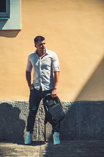 Young man with backpack enjoying walk city - Fotoğraf, Görsel