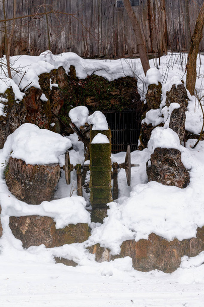 Old water mill, which is mossy and covered with snow. - Photo, Image