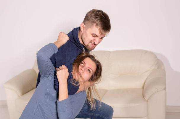 People, abuse and violence concept - aggressive man strangling his wife - Valokuva, kuva