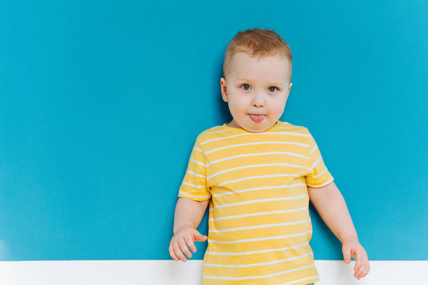 Portrait of cute shy blond little toddler boy in T-shirt - Zdjęcie, obraz