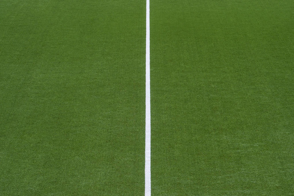 Artificial green turf texture background with white line marks - Photo, Image