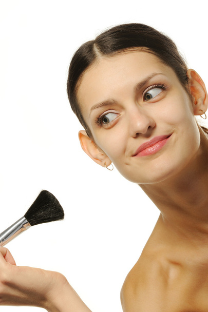 Pretty woman with a brush for a makeup - Photo, Image