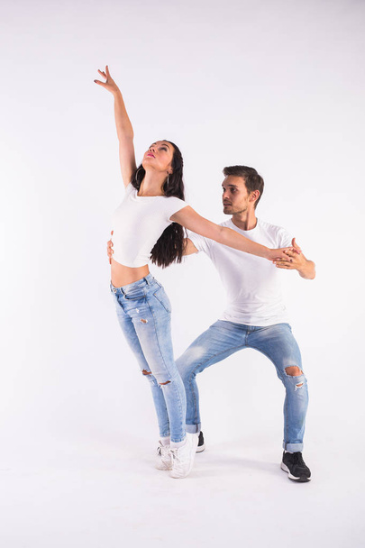 Страстная пара танцует социальный данс кизомба или бачата или семба или тараксия на белом фоне
 - Фото, изображение