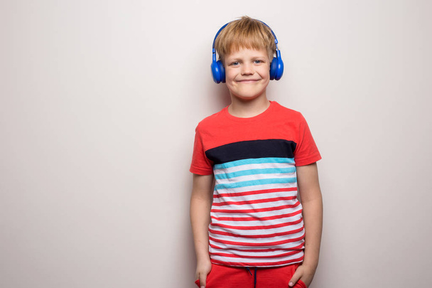 Kid Studio Shoot Using Headphone Listening Music. Isolated on white background - Fotó, kép