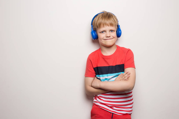 Kid Studio Shoot Using Headphone Listening Music. Isolated on white background - Fotó, kép