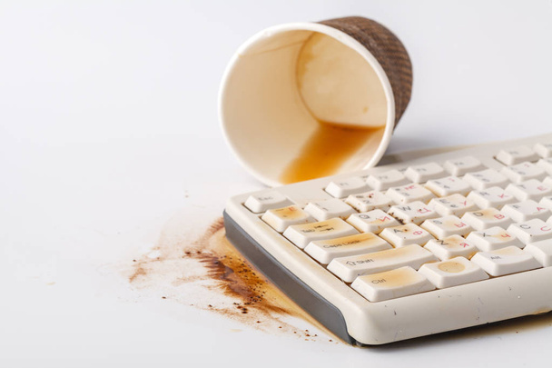 Result of eating in office, Coffee and damaged computer keyboard - 写真・画像