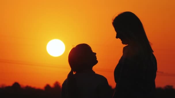 Μαμά και κόρη δείτε το όμορφο ηλιοβασίλεμα πάνω από την πόλη και τον πορτοκαλί ουρανό μαζί - Πλάνα, βίντεο