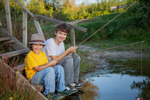 Happy boys go fishing on the river, Two children of the fisherma - Zdjęcie, obraz