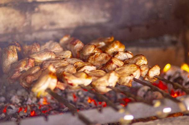 Grilled meat on skewers on the grill for the holiday barbecue - Photo, Image