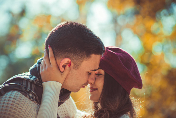 Pretty couple exchanges tenderness in the park - 写真・画像
