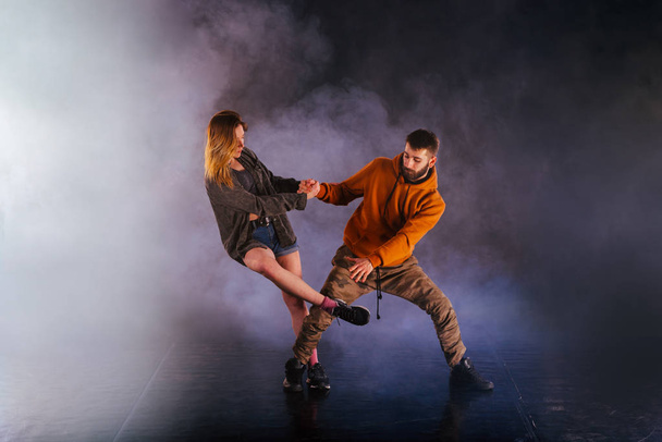 Tanzpaar zeigt seine Bewegungen, das Mädchen wirft sein Bein  - Foto, Bild