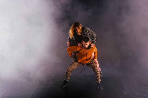 Strong male dancer and an elegant female dancer perform an exoti - Zdjęcie, obraz