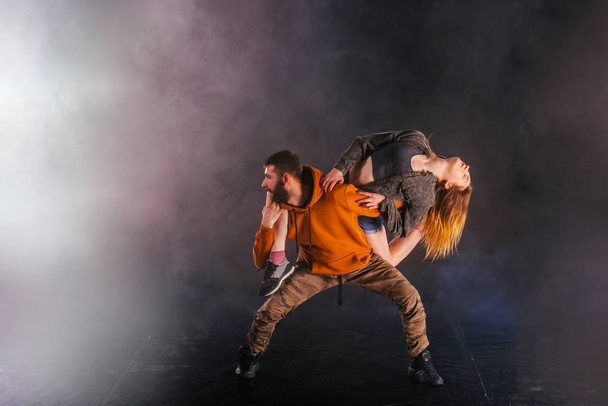 Strong male dancer and an elegant female dancer perform an exoti - Photo, Image