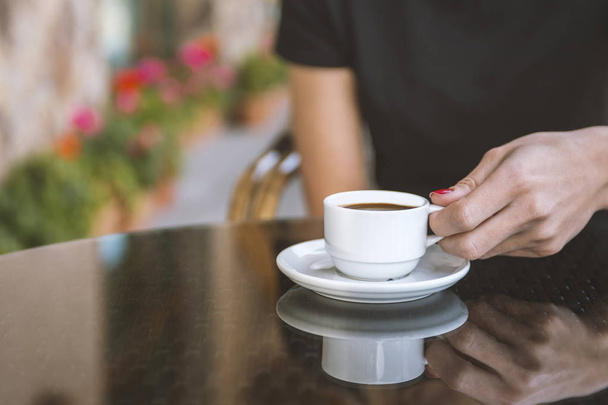 A girl is drinking coffee in a cafe. - Foto, Bild