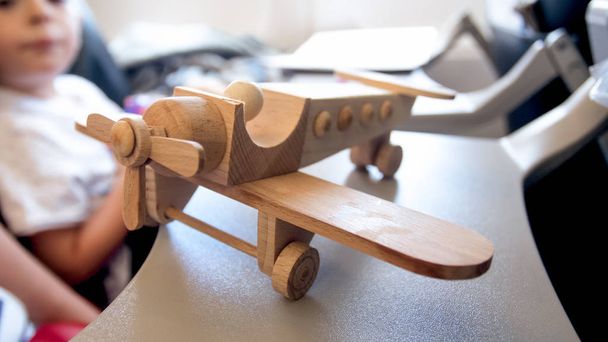 Closeup image of wooden toy miniature of pilot in plane in rela jet airplane - Φωτογραφία, εικόνα