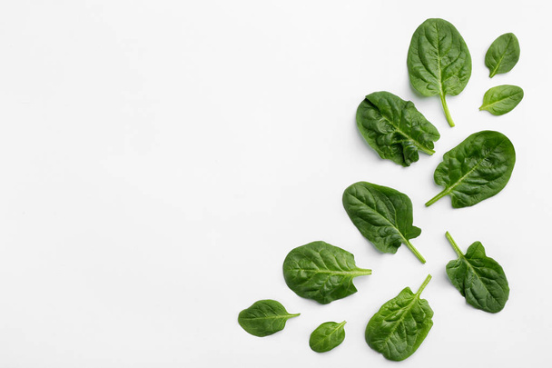 Fresh leaves of spinach isolated on white, top view - 写真・画像