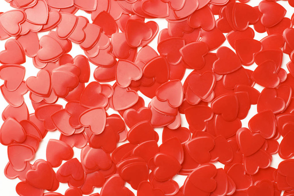 Red hearts confetti on white background close up, romance concept - Valokuva, kuva