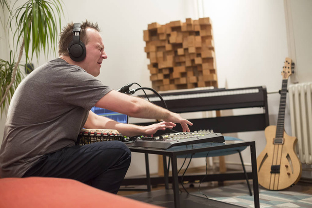 Musician playing midi keyboard in home music studio. - Photo, Image