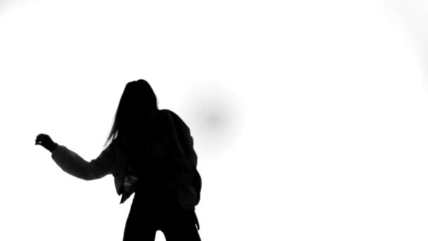 black silhouette on white background, girl dancing hip hop, street dance - Footage, Video