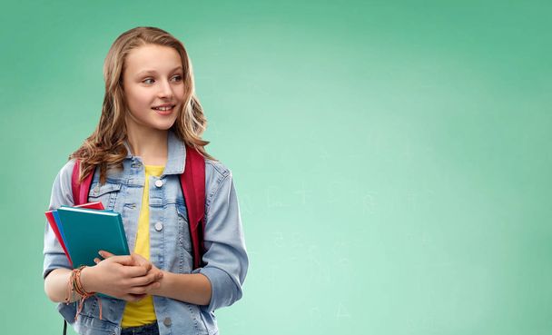 happy smiling teenage student girl with school bag - Фото, изображение