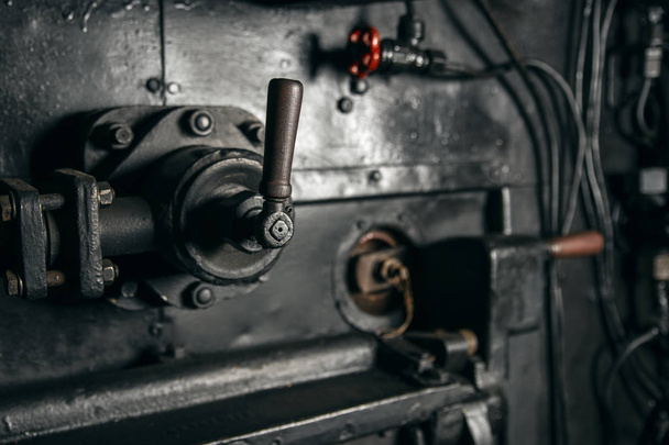 Metal lever mechanism with a wooden handle in the cabin of the l - Photo, Image