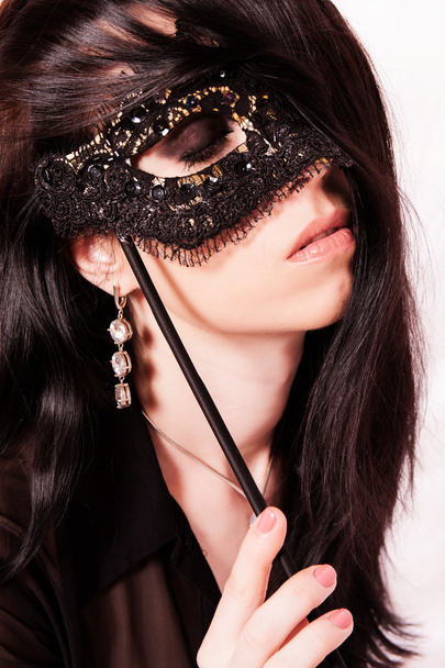 Beautiful young woman with a mask. - Фото, изображение