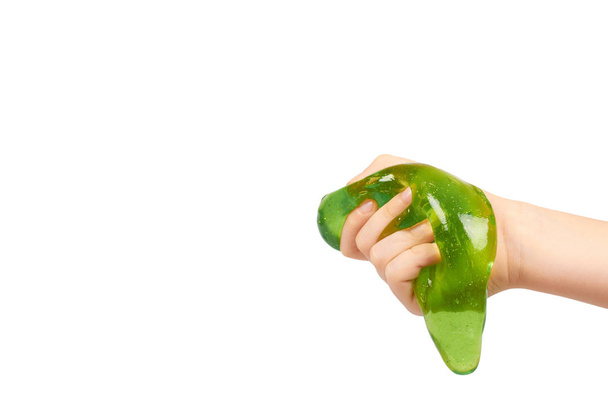 kid playing green slime with hand, transparent toy - Valokuva, kuva