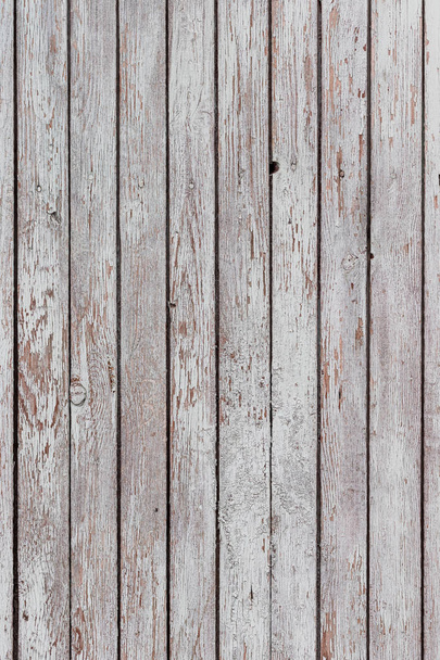 A whitewashed wooden surface worn out due to weather. Planks painted white. The texture of the wooden board. - Photo, Image