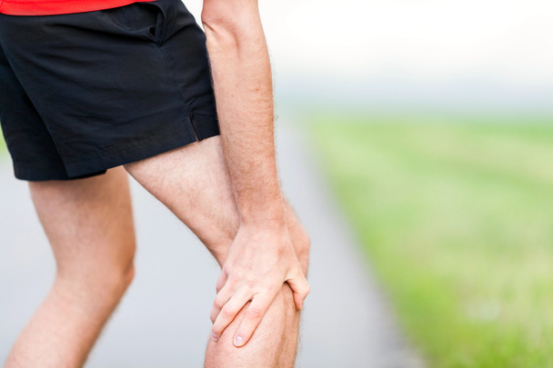 Runner leg and muscle pain during running training outdoors - Photo, Image